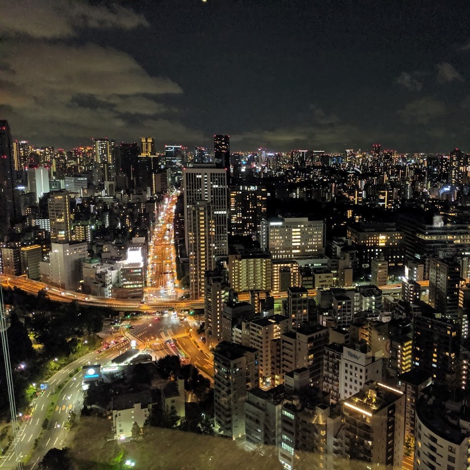 a night time skyline filled with lights of buildings and cars
